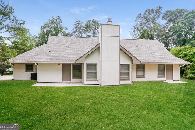 a view of a house with a yard and a garden