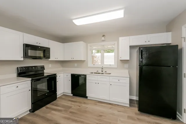 a kitchen with a refrigerator stove and sink