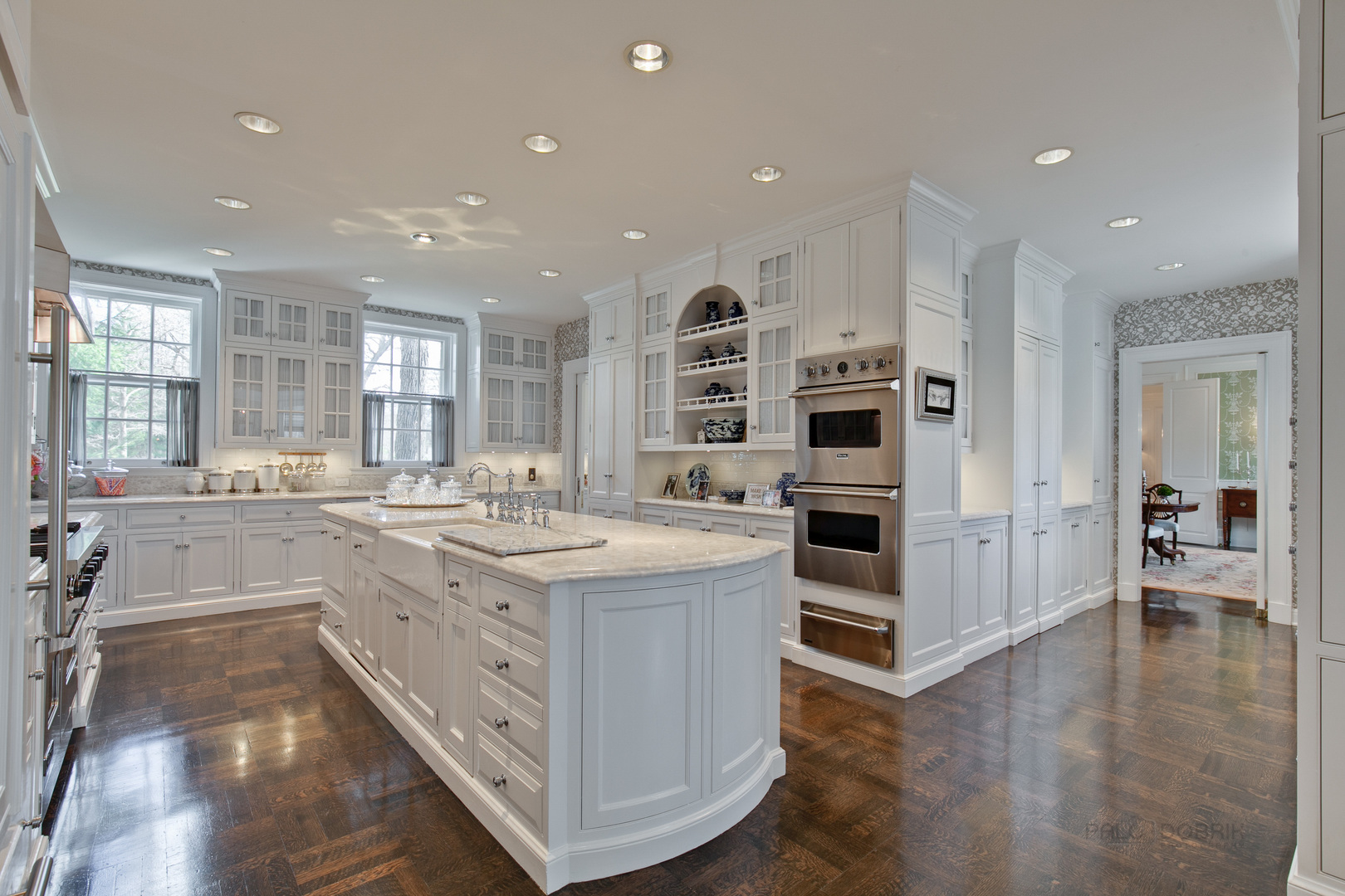 700 South Ridge Road Lake Forest, IL 60045 - Photo 13 of 47 a large white kitchen with a large counter top stainless steel appliances and wooden floor