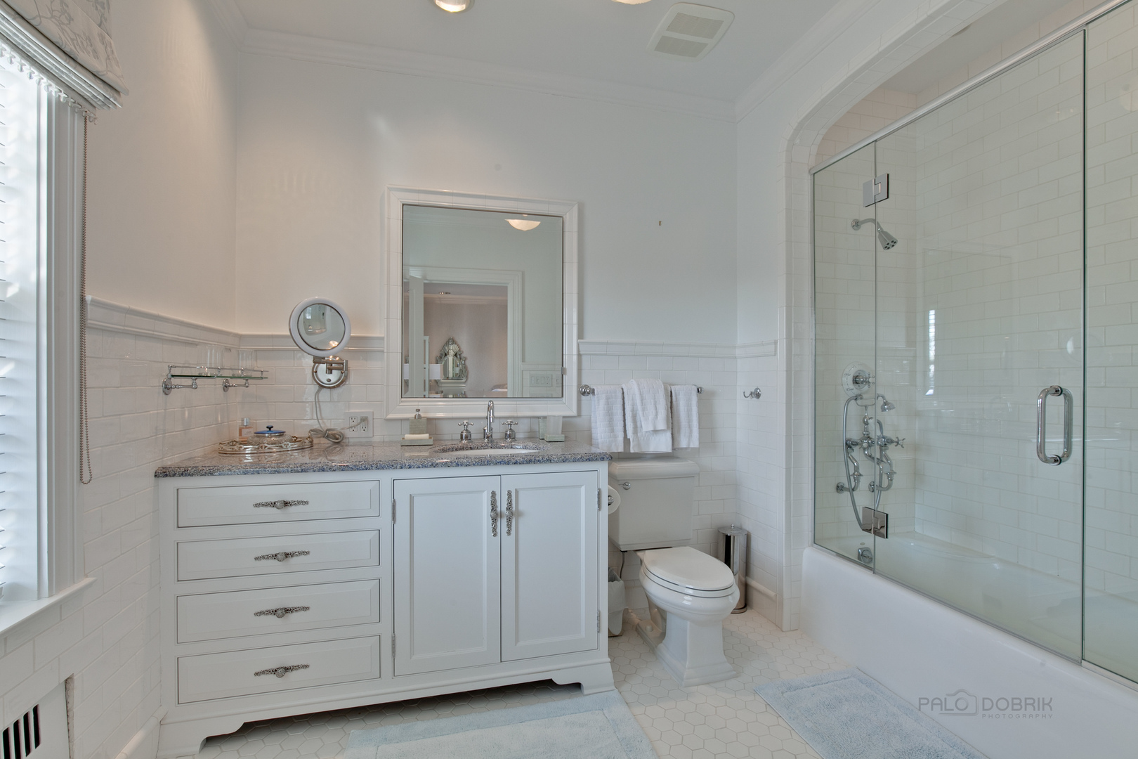 700 South Ridge Road Lake Forest, IL 60045 - Photo 25 of 47 a bathroom with a granite countertop toilet a sink and a mirror