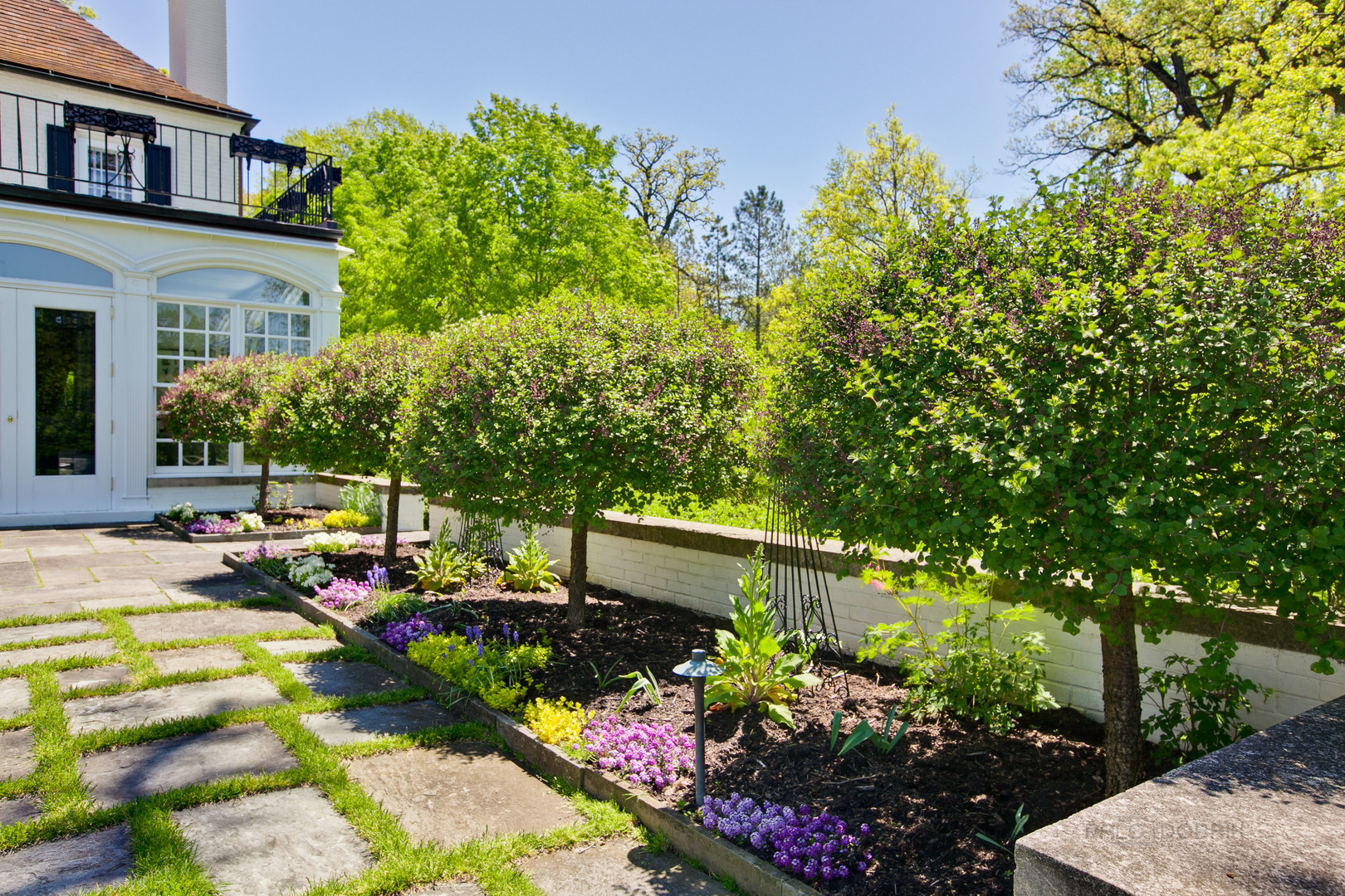 700 South Ridge Road Lake Forest, IL 60045 - Photo 36 of 47 a view of a backyard with plants and patio