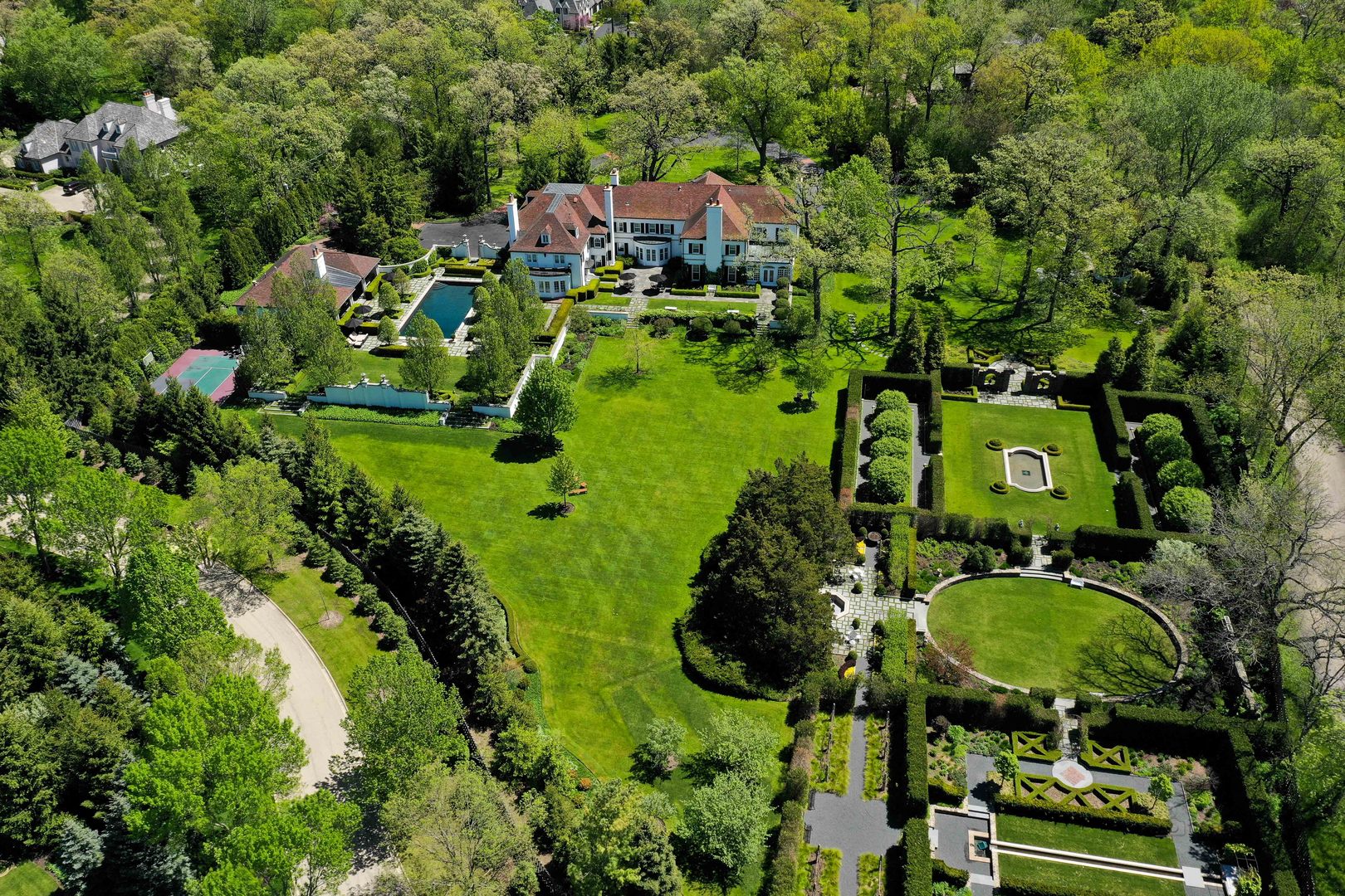 700 South Ridge Road Lake Forest, IL 60045 - Photo 46 of 47 a backyard of a house with a garden and lots of trees
