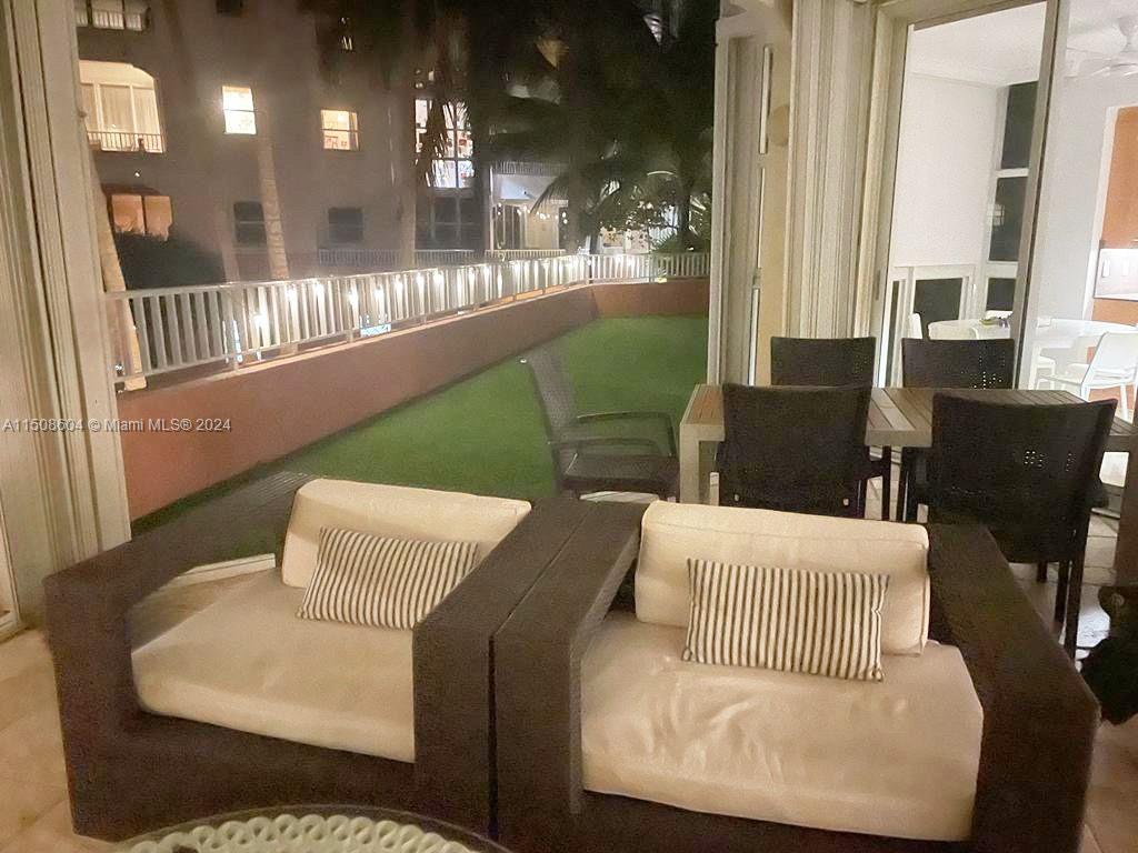 727 Crandon Boulevard, Unit 202 Key Biscayne, FL 33149 - Photo 5 of 32 a living room with furniture and a large window