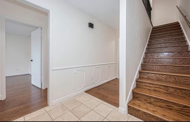 a bathroom with a granite countertop sink a toilet and shower
