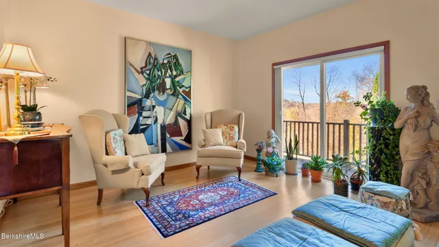a living room with furniture a rug and a window