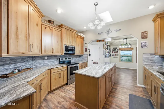 a patio with a table and chairs under an umbrella