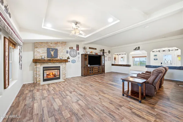 an empty room with windows and ceiling fan