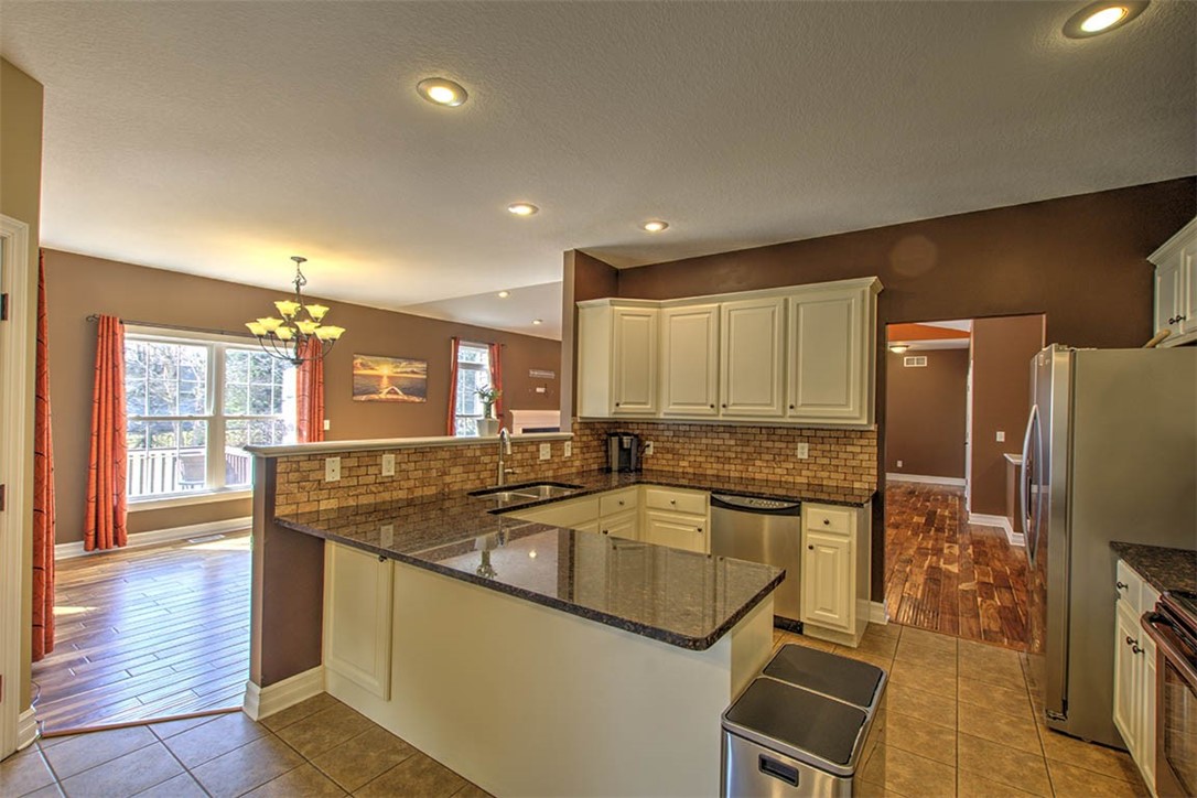 6625 Sherry Court Decatur, IL 62521 - Photo 14 of 42 a kitchen with stainless steel appliances granite countertop a sink a stove and refrigerator
