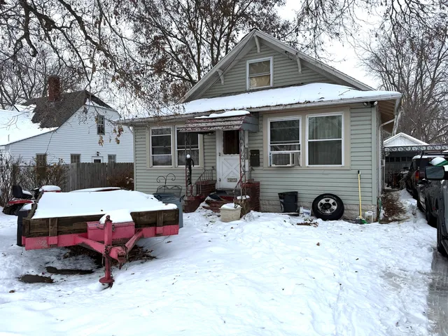 a view of a house with a yard covered in snow
