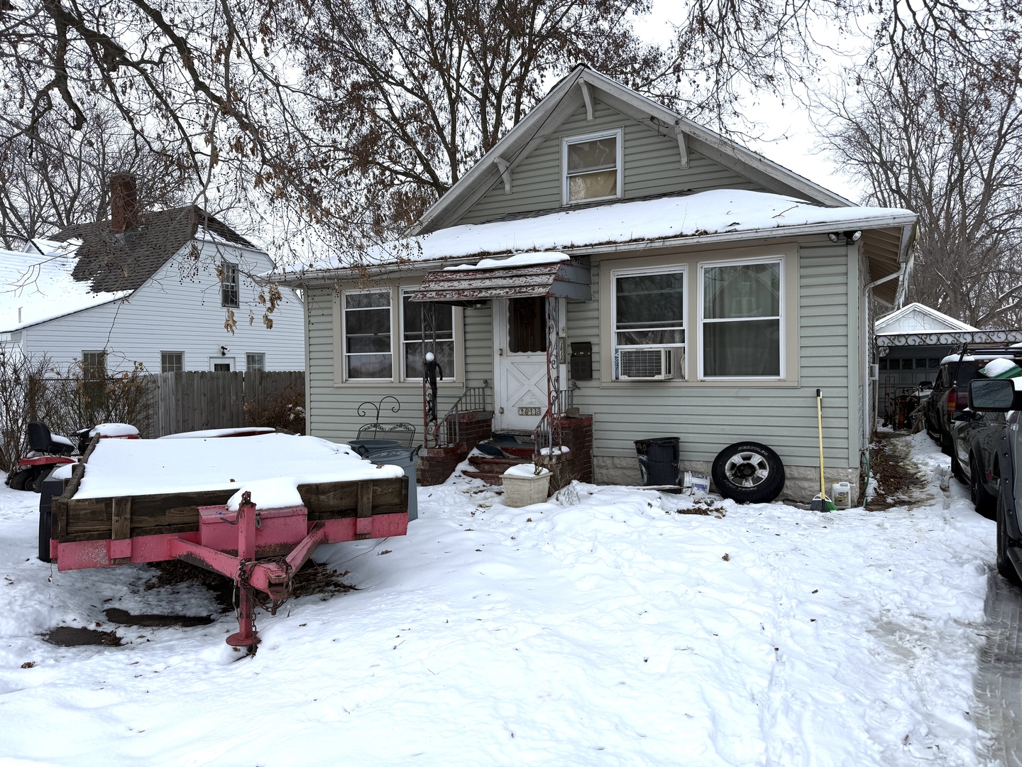 a view of a house with a yard covered in snow