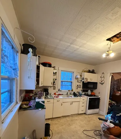 a kitchen with furniture appliances cabinets and a counter top space