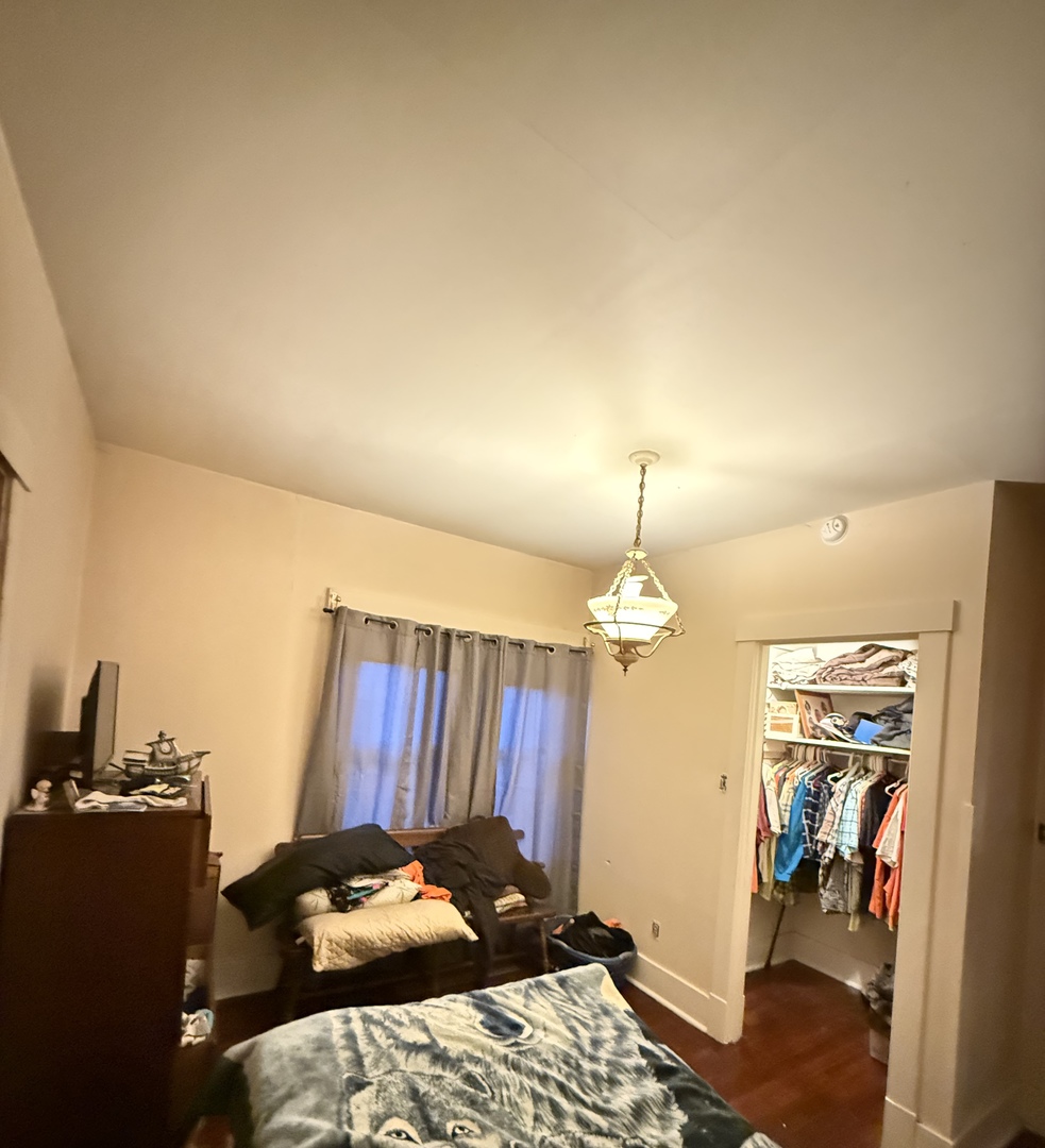 1611 West 3rd Street Dixon, IL 61021 - Photo 5 of 6 a bedroom with a bed and wooden floor