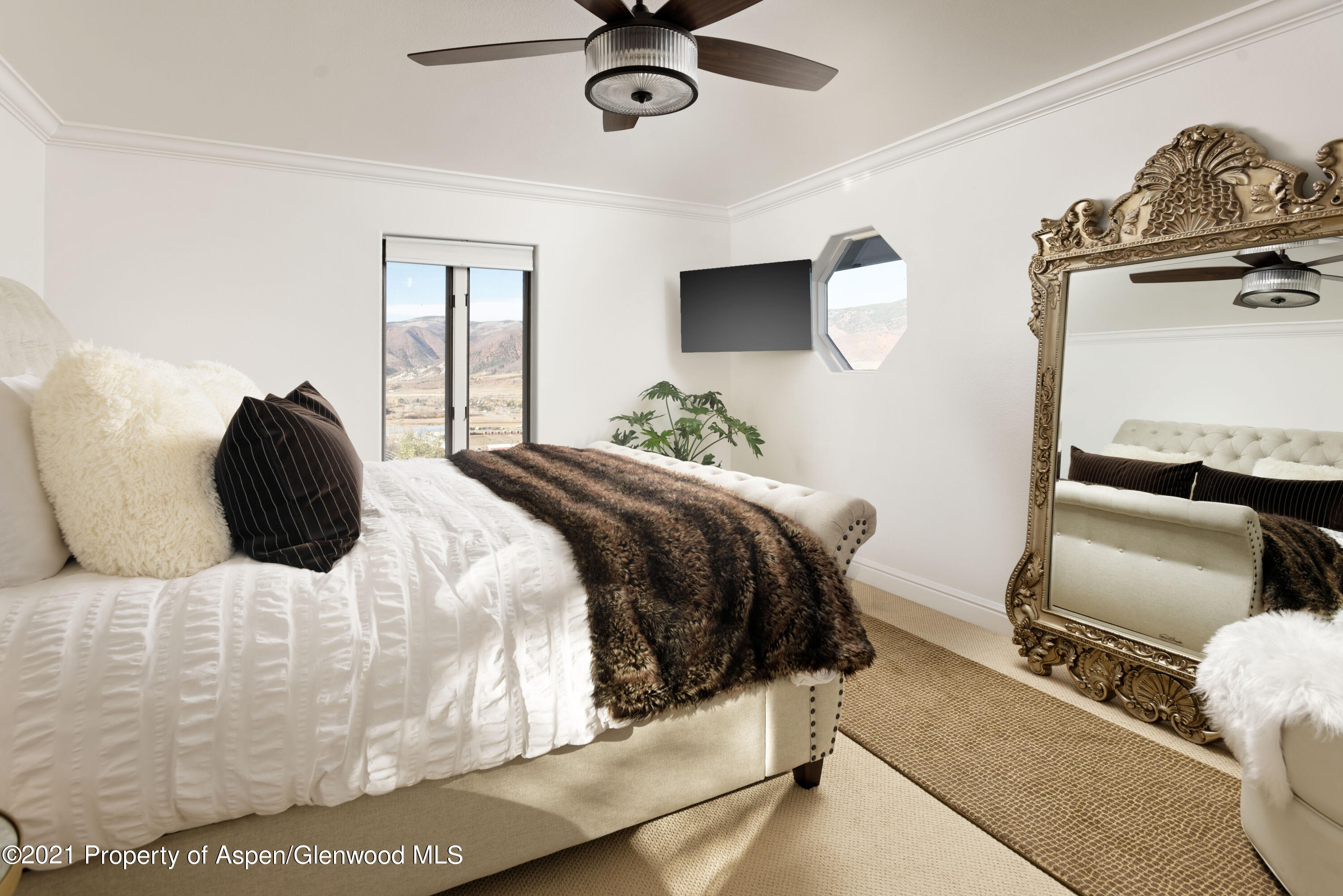 474 Upper Ranch Road Aspen, CO 81611 - Photo 12 of 43 a bedroom with a bed and wooden floor