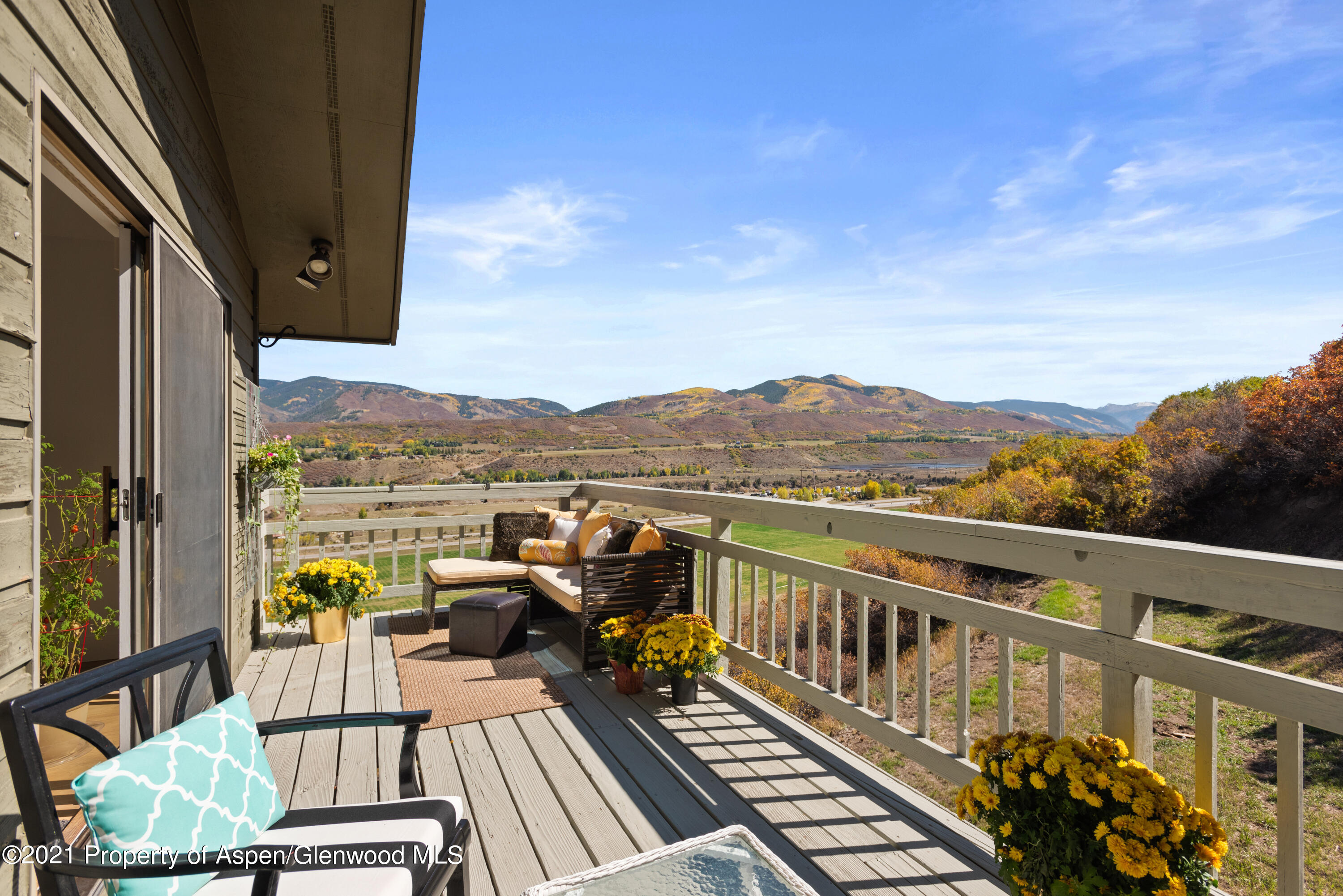 474 Upper Ranch Road Aspen, CO 81611 - Photo 21 of 43 a view of a balcony with wooden floor and outdoor seating
