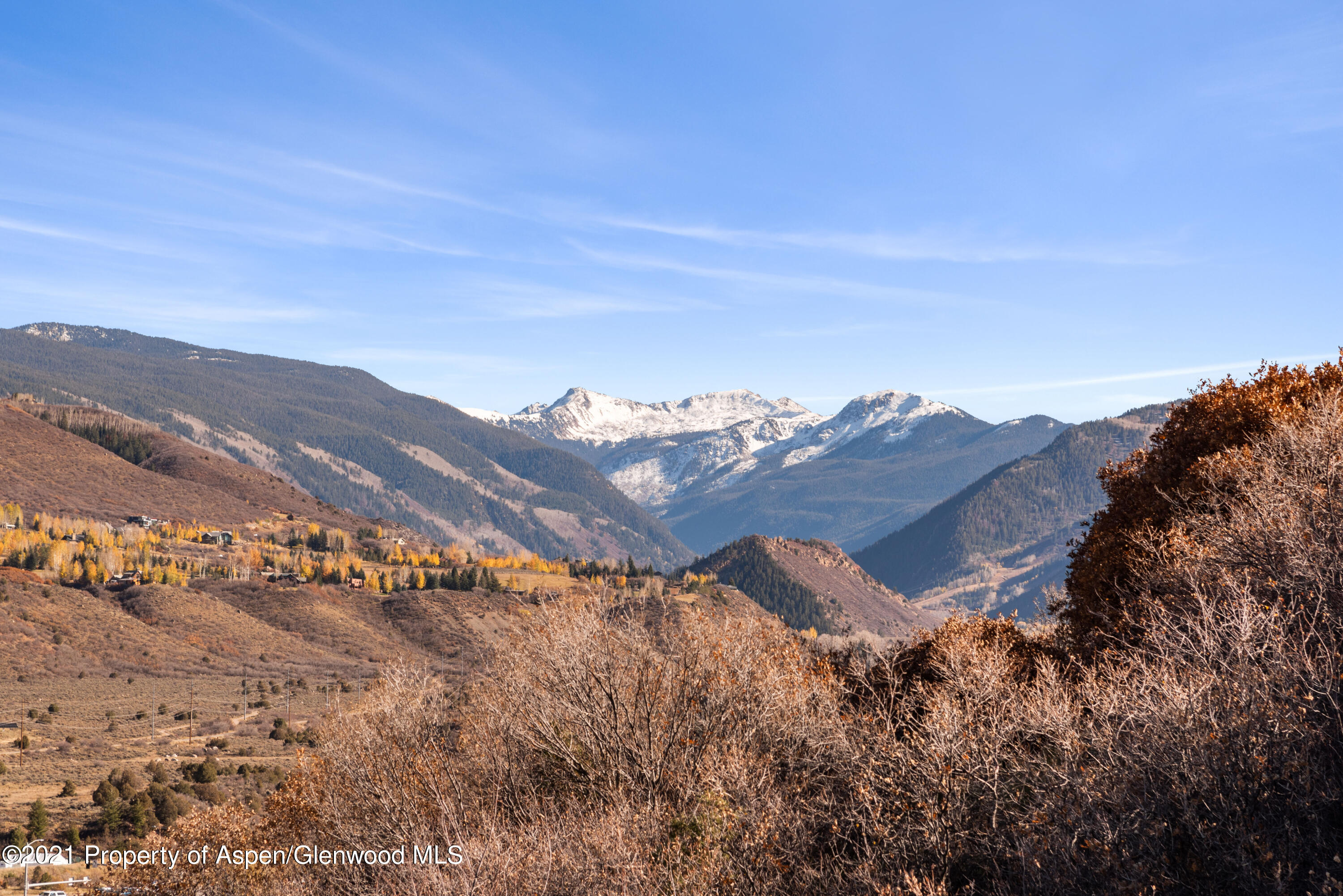 474 Upper Ranch Road Aspen, CO 81611 - Photo 26 of 43 a view of a large building with a mountain in the background