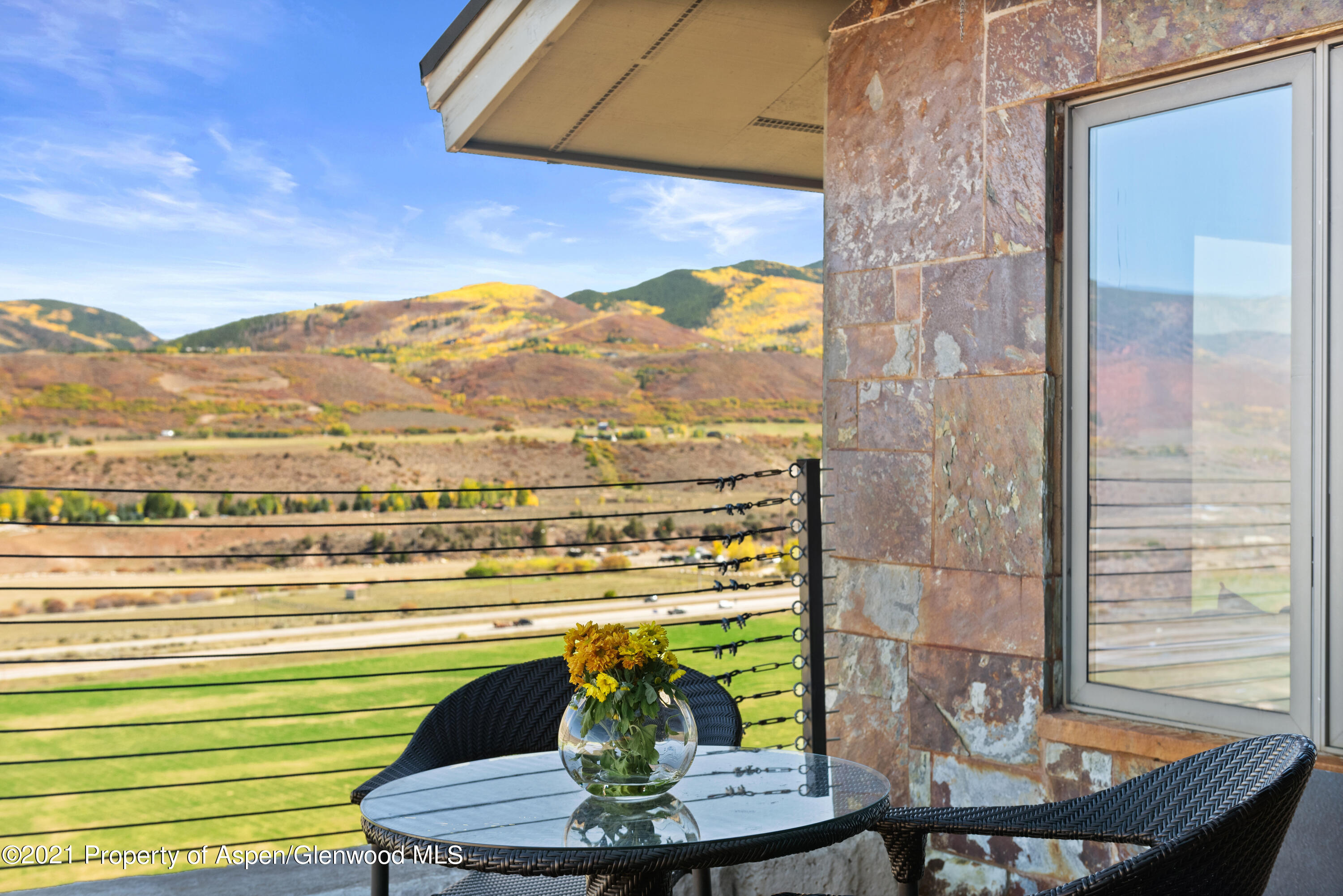 474 Upper Ranch Road Aspen, CO 81611 - Photo 43 of 43 a view of a dining room with furniture and wooden floor