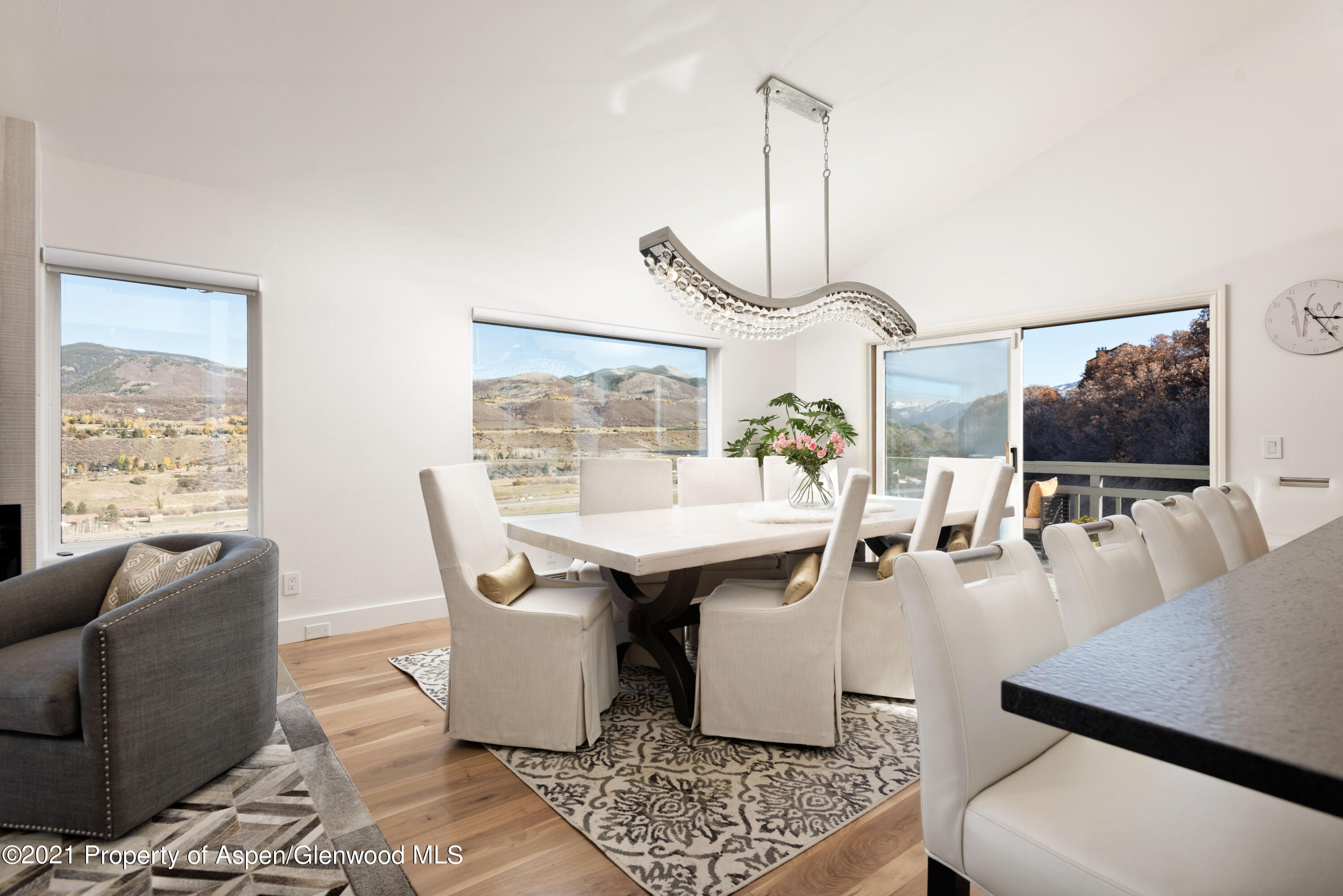 474 Upper Ranch Road Aspen, CO 81611 - Photo 5 of 43 a living room with furniture a flat screen tv and a large window