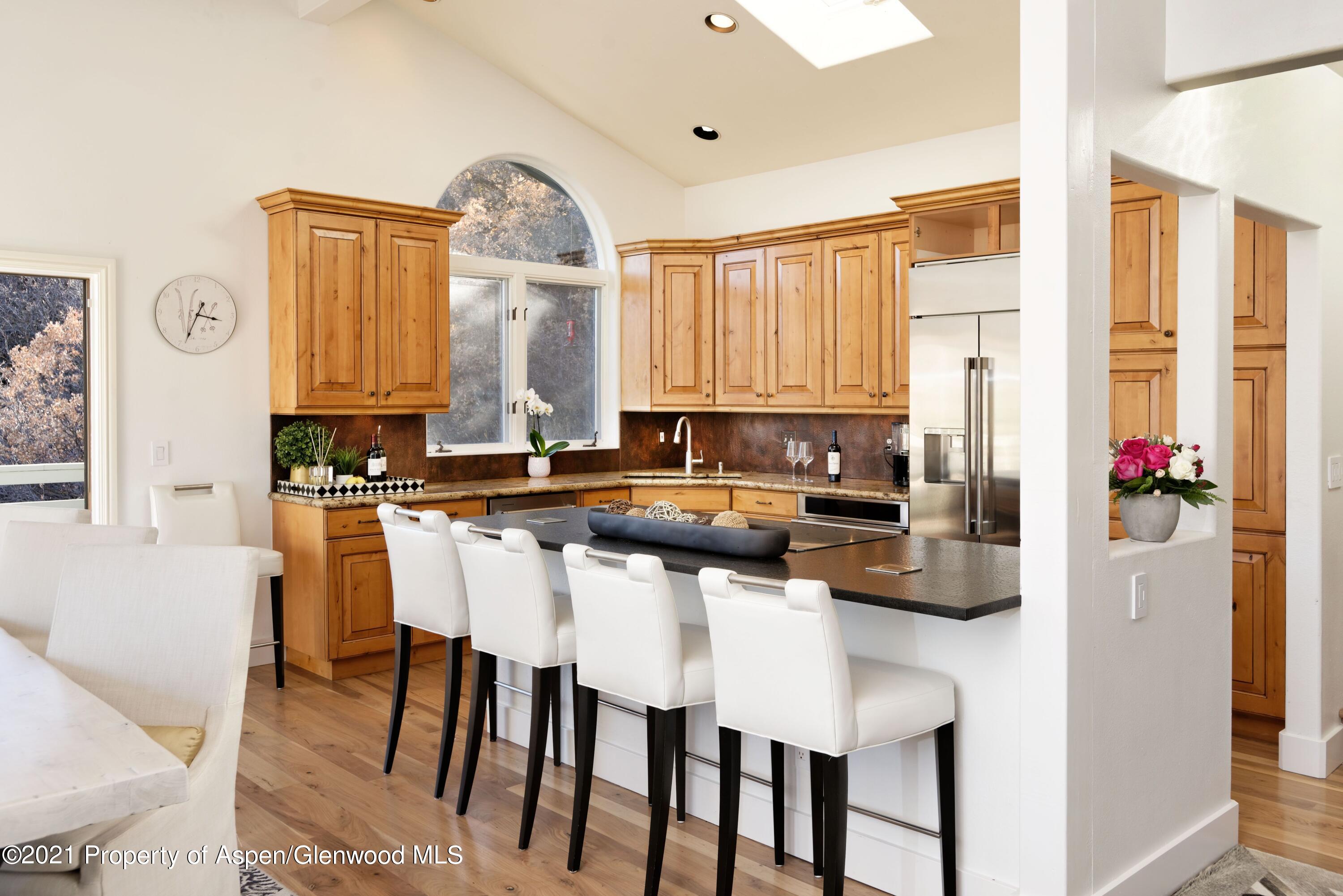 474 Upper Ranch Road Aspen, CO 81611 - Photo 10 of 43 a kitchen with a table chairs sink and cabinets