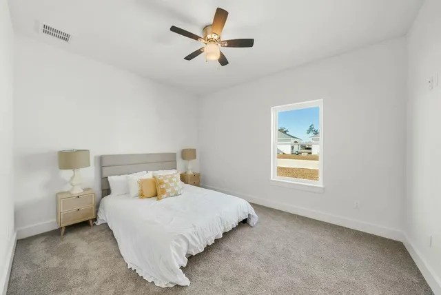 a bedroom with bed and window
