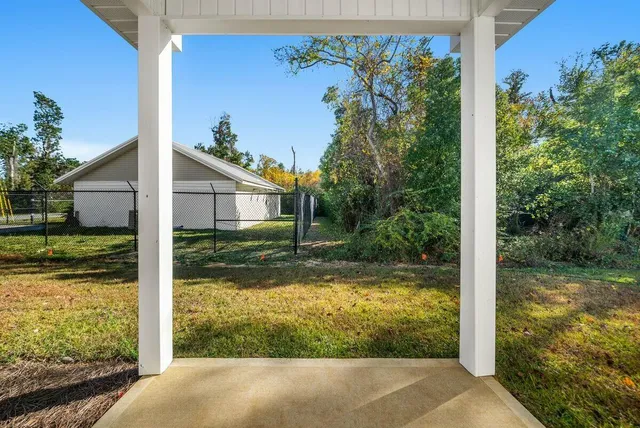 a backyard of a house with table and chairs