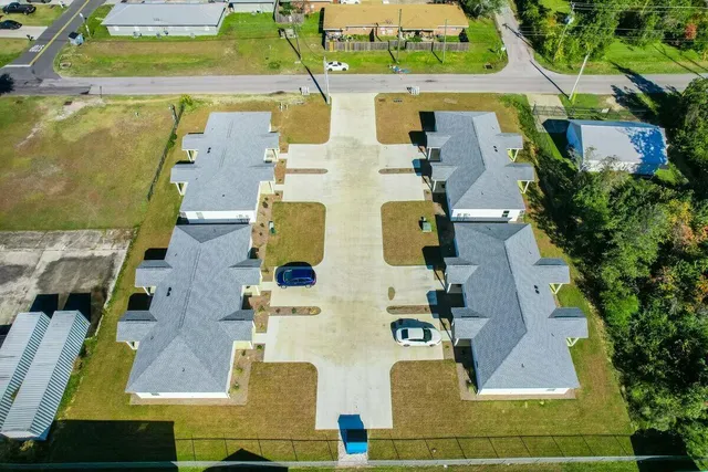 an aerial view of residential house with outdoor space and parking