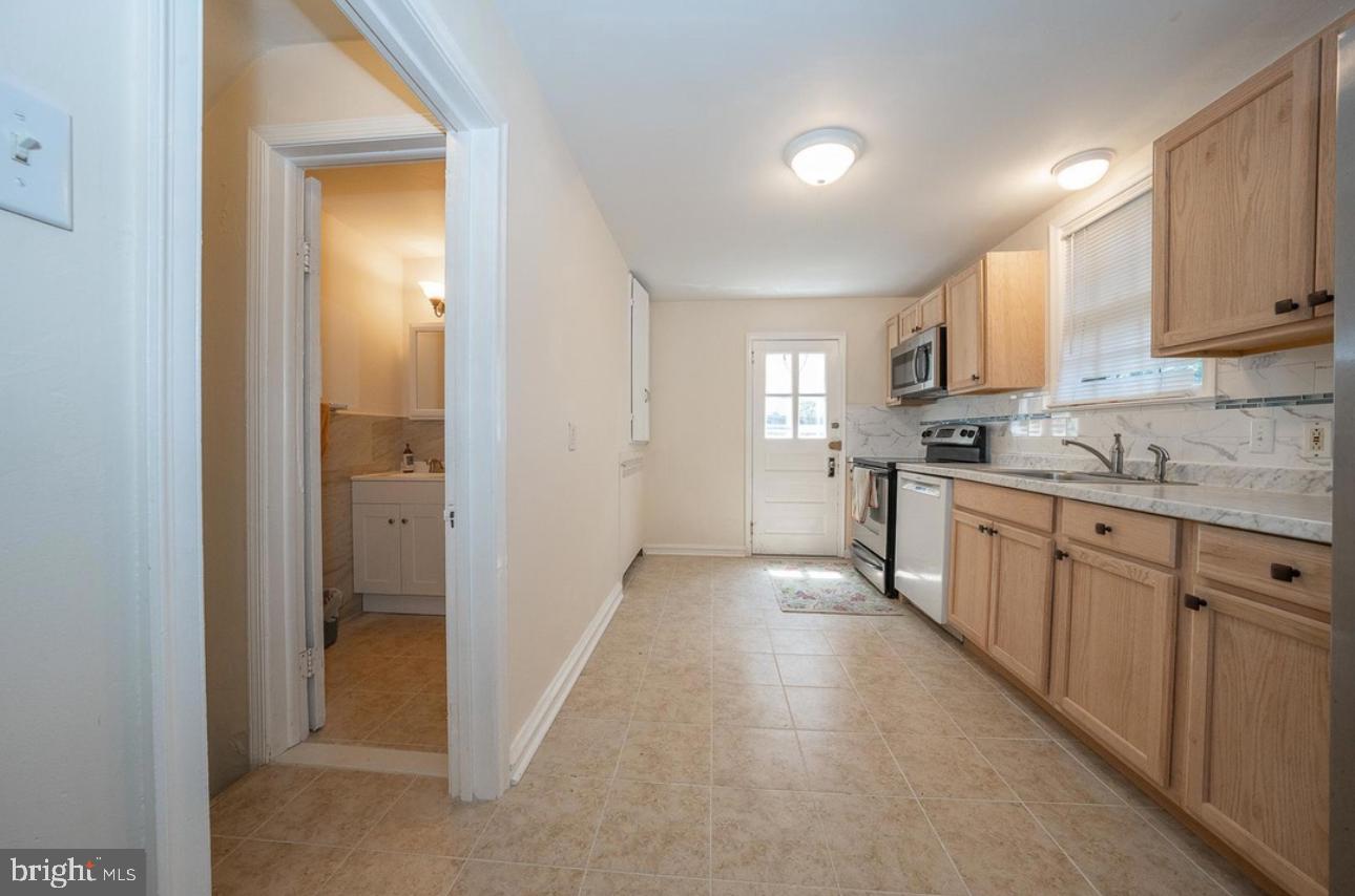 130 Crosshill Road Wynnewood, PA 19096 - Photo 4 of 9 a kitchen with cabinets a sink and appliances