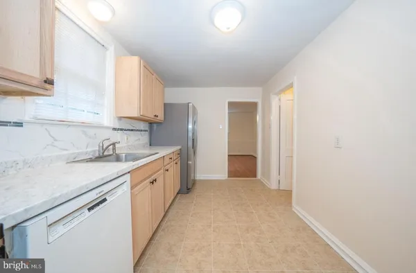 a large kitchen with a sink and cabinets