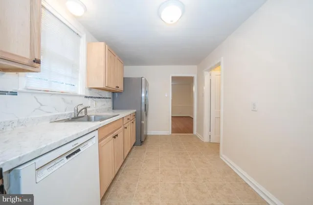 a large kitchen with a sink and cabinets