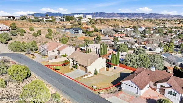 an aerial view of a house with a mountain