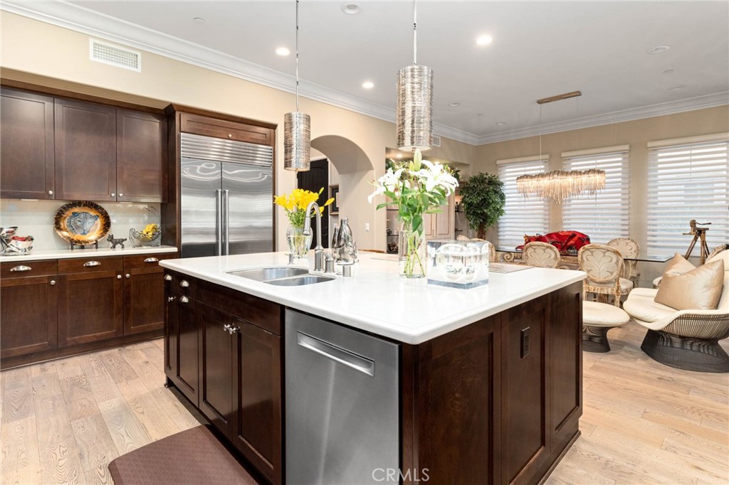 7 Zephyr Irvine, CA 92602 - Photo 16 of 52 a kitchen with kitchen island granite countertop a sink appliances and cabinets
