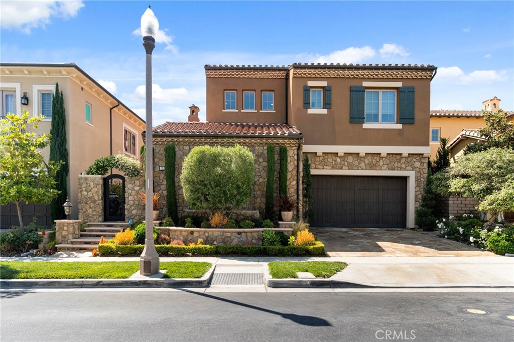 7 Zephyr Irvine, CA 92602 - Photo 2 of 52 a front view of a house with a yard and garage