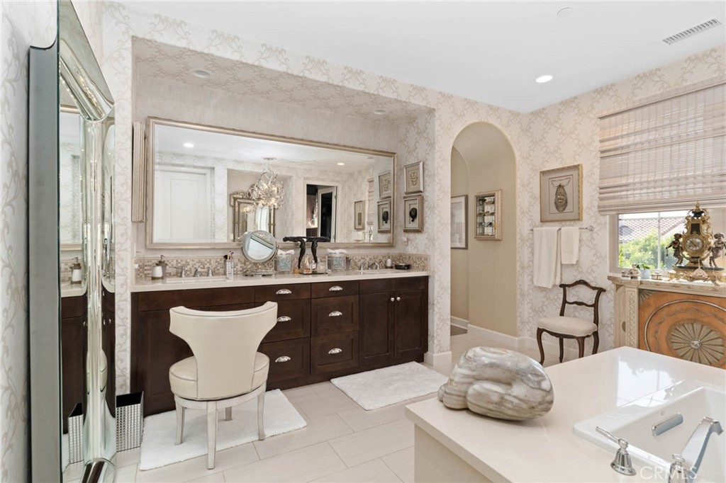 7 Zephyr Irvine, CA 92602 - Photo 35 of 52 a living room with furniture a sink and a large mirror with potted plants