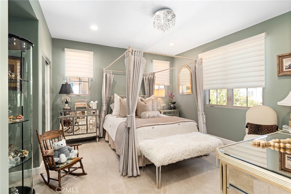 7 Zephyr Irvine, CA 92602 - Photo 40 of 52 a bedroom with a bed and a chandelier