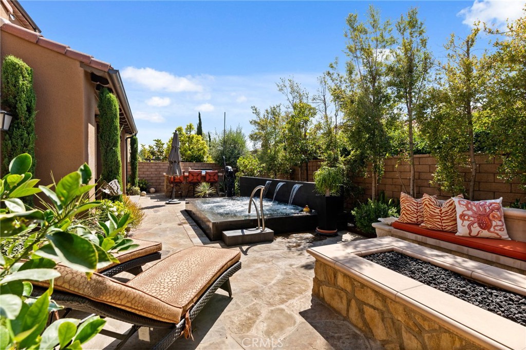 7 Zephyr Irvine, CA 92602 - Photo 45 of 52 a view of a patio with couches and a table and chairs with potted plants