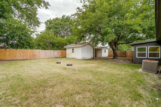 a large kitchen with stainless steel appliances granite countertop a large counter top a sink and a refrigerator