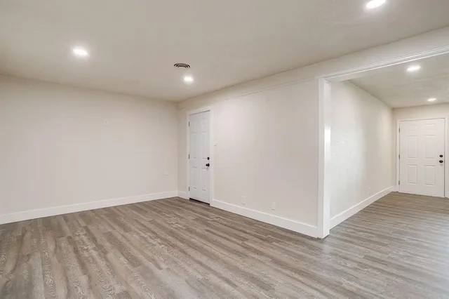 a view of a kitchen with a sink and wooden floor