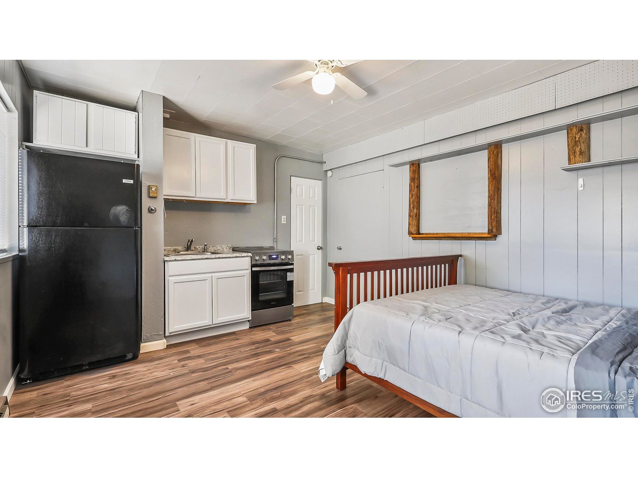 1408 Edison Street Brush, CO 80723 - Photo 13 of 23 a bedroom with a bed and a view of kitchen