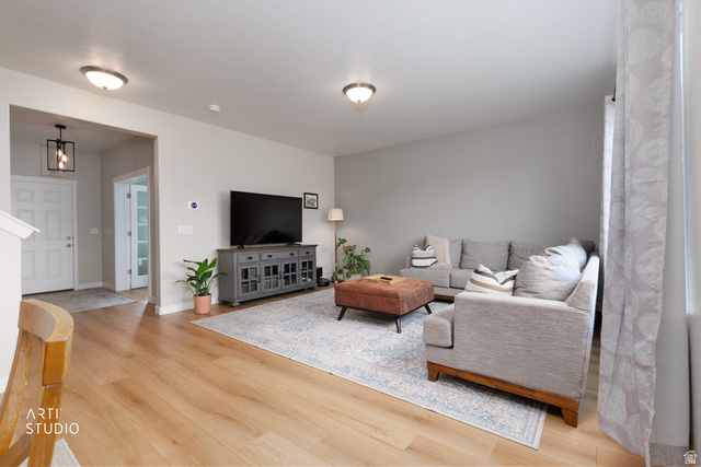 1654 South 730 West Provo, UT 84601 - Photo 6 of 33 Bright living space featuring wood-finish flooring, recessed lighting, and a modern ceiling light fixture at the entryway