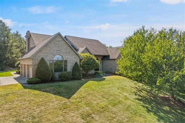a view of a house with a yard and potted plants