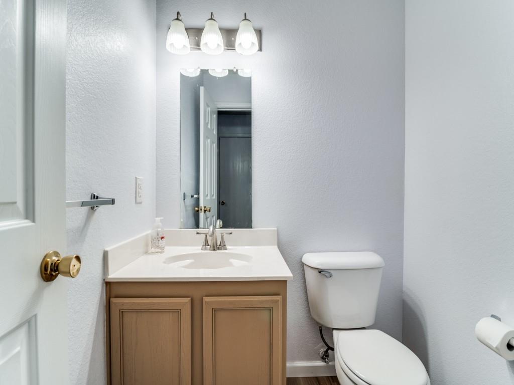 3100 Misty Ridge Lane Rockwall, TX 75032 - Photo 11 of 25 a bathroom with a sink a toilet and mirror