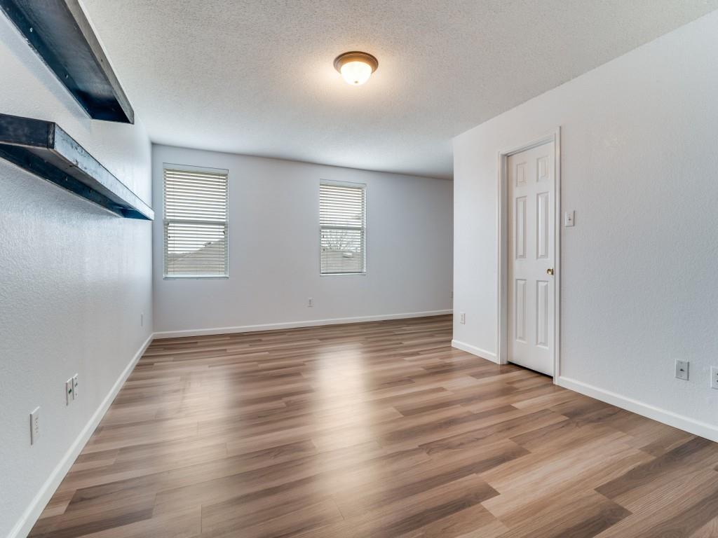 3100 Misty Ridge Lane Rockwall, TX 75032 - Photo 16 of 25 an empty room with wooden floor and windows