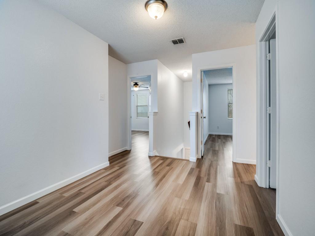 3100 Misty Ridge Lane Rockwall, TX 75032 - Photo 17 of 25 a view of a hallway with wooden floor