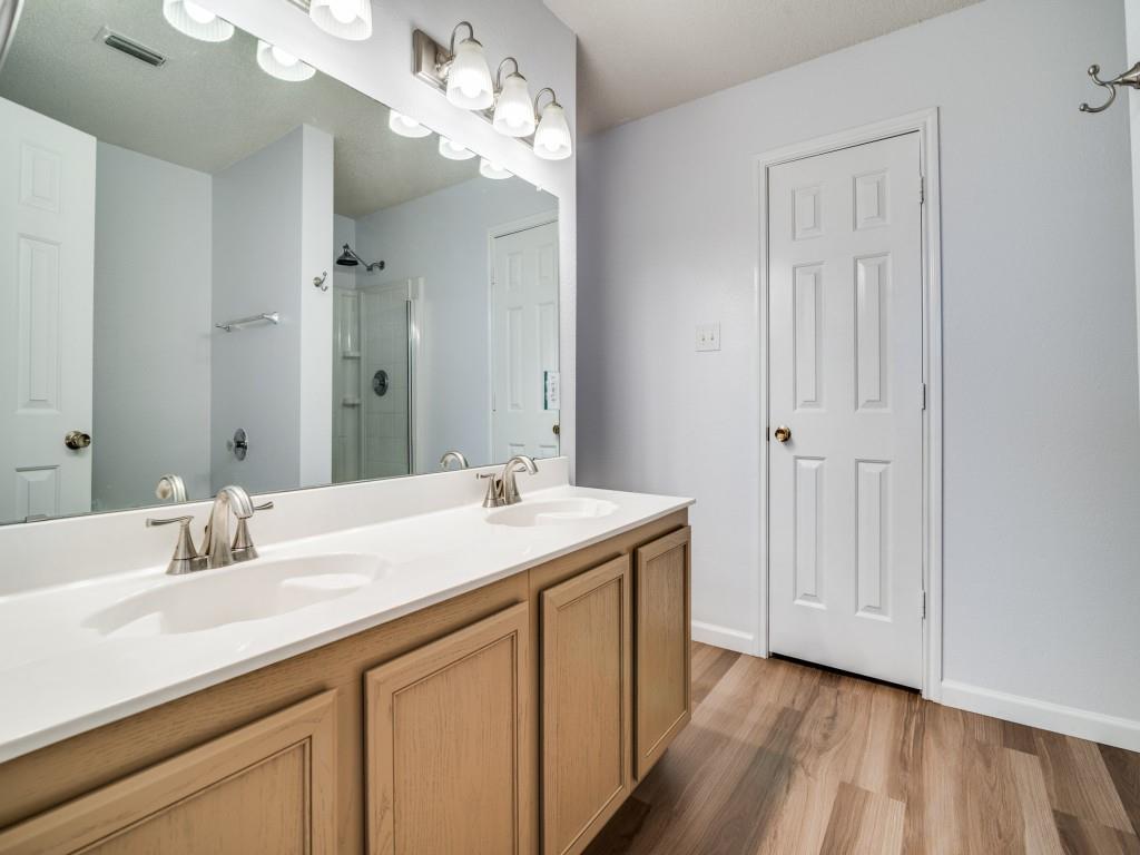 3100 Misty Ridge Lane Rockwall, TX 75032 - Photo 20 of 25 a bathroom with a sink double vanity and a mirror