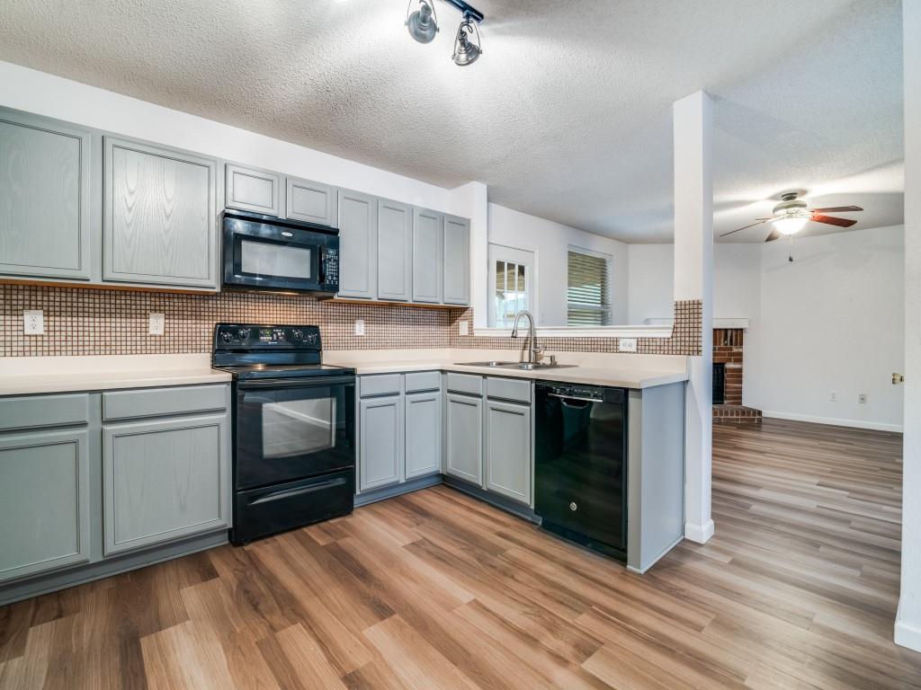 3100 Misty Ridge Lane Rockwall, TX 75032 - Photo 3 of 25 a kitchen with a sink cabinets and appliances
