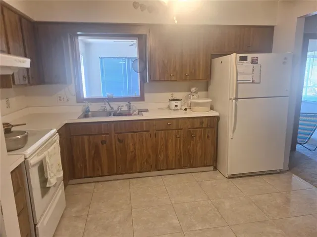 a utility room with cabinets washer and dryer