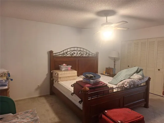 a bed room with furniture and a chair
