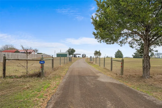 a view of a pathway with a wrought fence