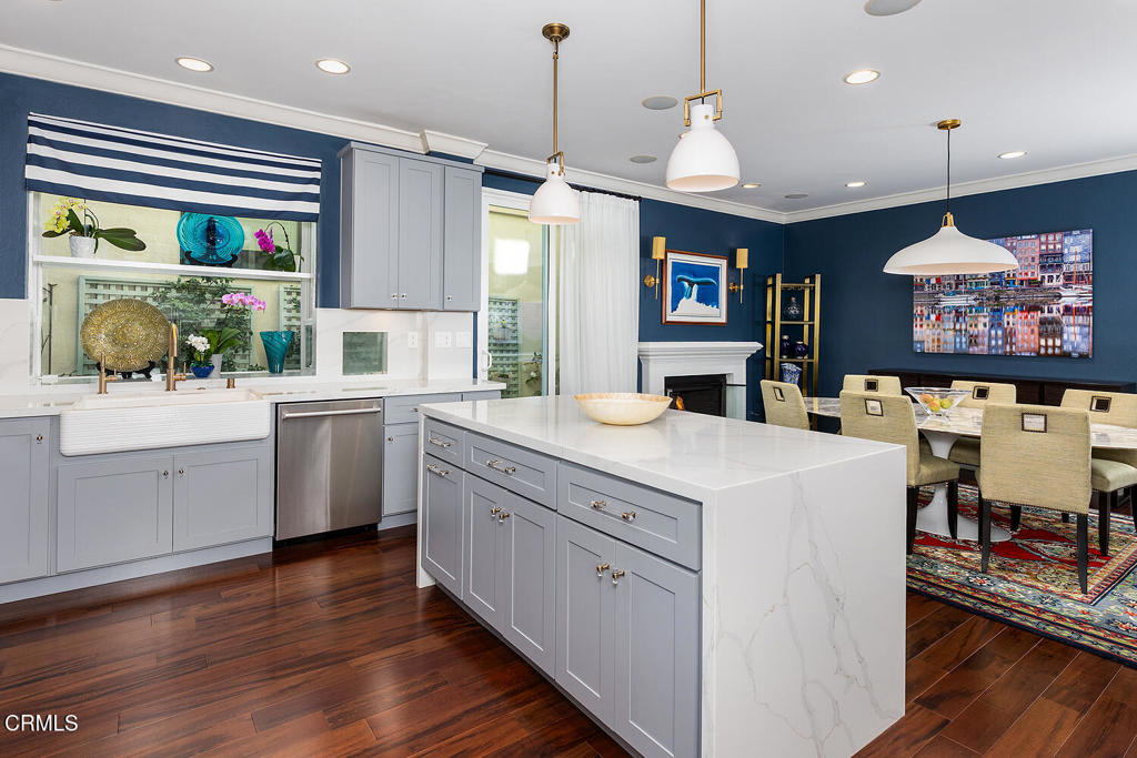 411 22nd Street Huntington Beach, CA 92648 - Photo 13 of 38 a kitchen that has a lot of cabinets in it and wooden floors