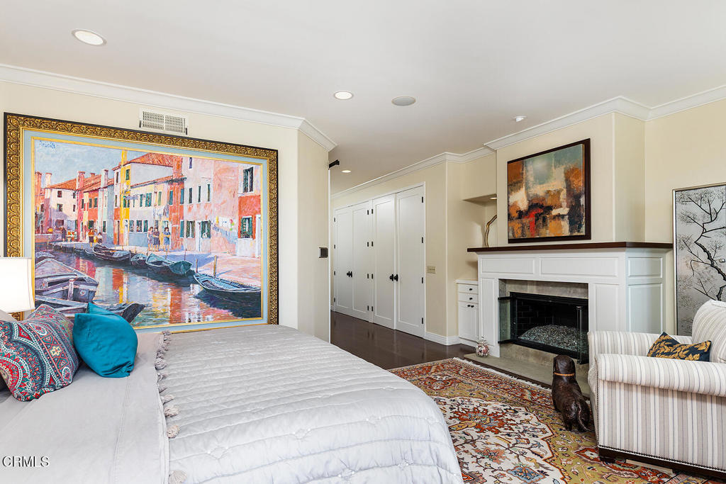 411 22nd Street Huntington Beach, CA 92648 - Photo 21 of 38 a bedroom with furniture and a fireplace