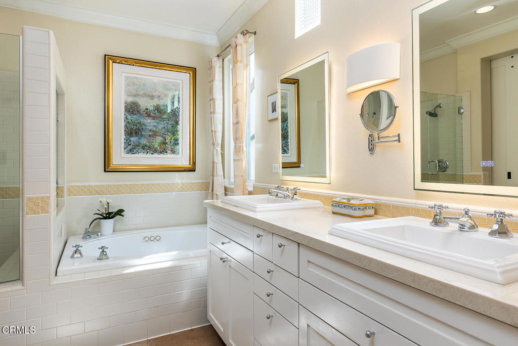 411 22nd Street Huntington Beach, CA 92648 - Photo 23 of 38 a bathroom with a tub a sink and a mirror